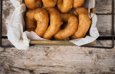 Homemade donuts with icing sugar powder on a wooden background