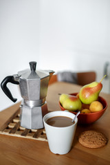 Still life. Morning healthy breakfast: Mug of coffee, oatmeal cookies, fruit pear on a wooden table.