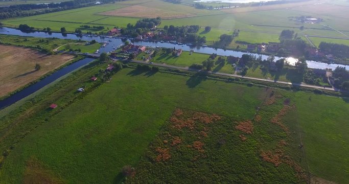 Minge village near the river. Drone camera flaying over the marina on a countryside on a sunny summer day - 009