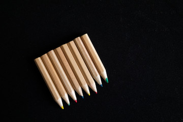 colored pencils on dark background