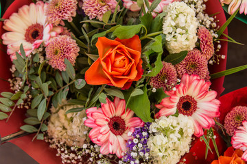 Bouquet with an orange rose in the center