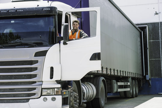 Worker standing by lorry door