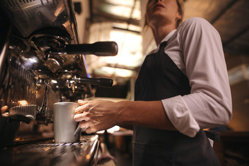 Fototapeta na wymiar Barista making coffee on coffee maker machine