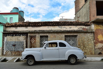 Cuban old city and 1950's classic car in Trinidad Centro Historico