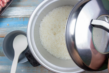 Chef open lip of electric rice cooker