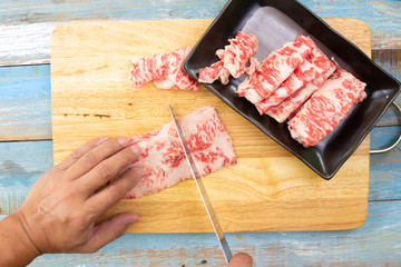 Chef slicing wagyu beef for cooking