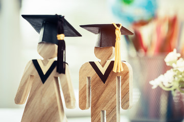 Back to School Concept, People Sign wood with Graduation celebrating cap on open textbook show alternative studying. Graduate or Education knowledge learning study abroad international Ideas.