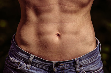 Naklejka premium Muscular tightened female abdomen /woman with perfect abdominal