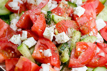 Fresh assorted green salad with cucumbers and tomatoes.
