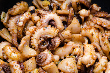 Close up of tasty plate of cooked octopus with paprika and olive oil