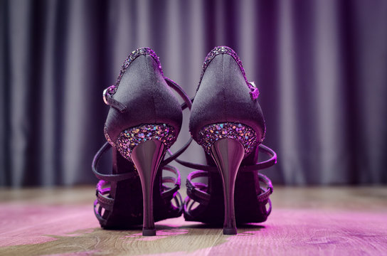 Black latin dance shoes on wooden floor