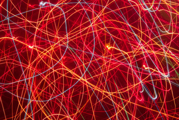 Blurred colorful lights in motion. Abstract background in red tones