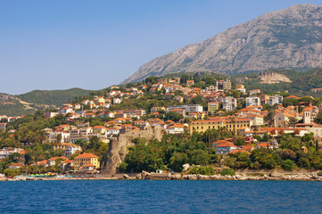 Fototapeta na wymiar Sunny Mediterranean landscape. Montenegro. View of coastal town of Herceg Novi located at the foot of Mount Orjen