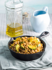 Buckwheat with zucchini and turmeric in cast iron skillet. Easy and healthy lunch for celiac gluten free diet