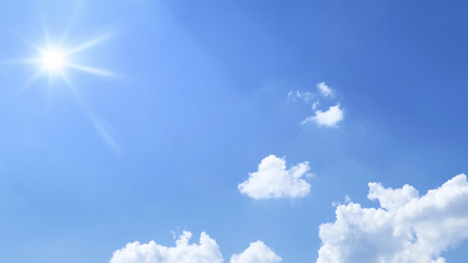 Naklejka na ściany i meble bright blue sky with sun and clouds background