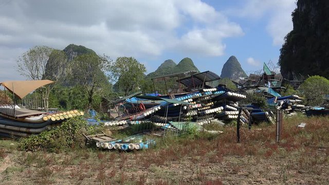 Dump of old raft boats at the bank of Li River. Yangshuo, Guilin, Guangxi Zhuang, China 