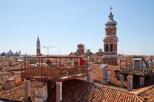 Fototapeta Elevated view of Venice roofs with typical altana balcony and San Marco bell tower in summer, Italy