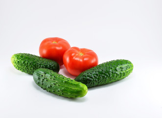 Ripe red tomatoes and cucumbers from the garden.