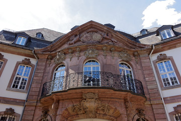 Street photography. Historic, classicist buildings in Trier, Germany. Blue sky with clouds.