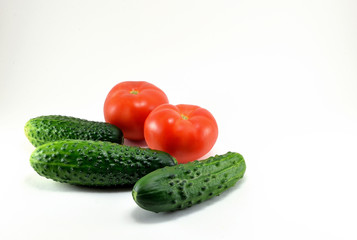 Ripe red tomatoes and cucumbers from the garden.