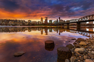 A colorful beautiful sunset over downtown city skyline of Portland Oregon from Eastbank Esplanade evening time