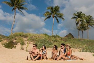 Group of friends having fun in the beach