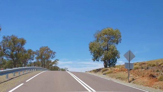 Car driving on empty road at daytime