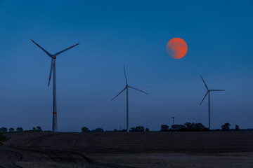 windmills during night - red moon lunar eclipse