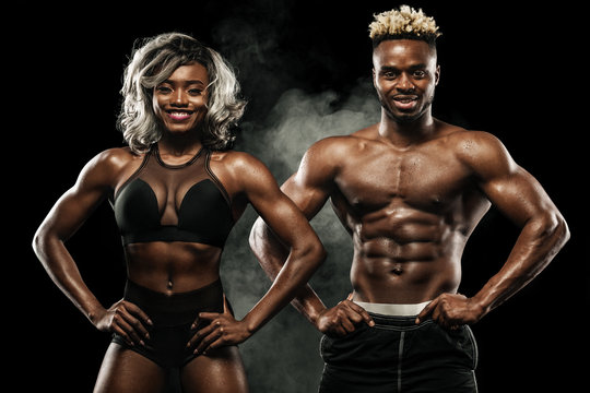 Fitness couple of athletes posing on black background, healthy lifestyle body care. Sport concept with copy space.