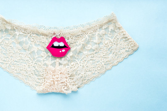 beige lace briefs on a blue background. concept sex