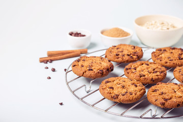 Oatmeal chocolate chip cookies on a round grate for cooling