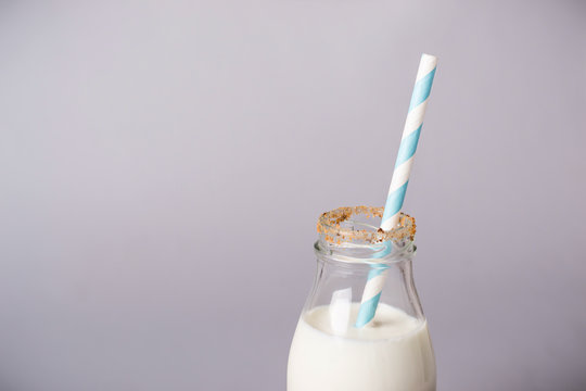 bottle of milk is decorated with cookies crumbs