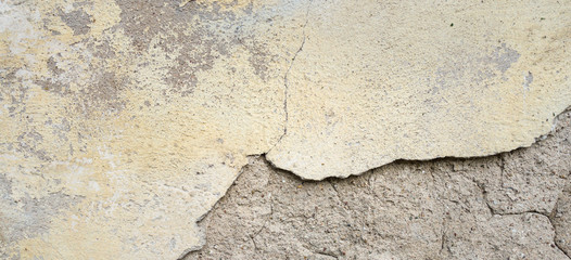 Obraz premium Old Wall With Peel Grey Stucco Texture. Retro Vintage Worn Wall Background. Decayed Cracked Rough Abstract Banner Surface.