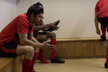 Football players sitting on bench