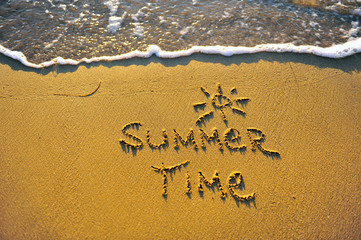 Summer time sign on sandy beach