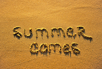 Summer comes, hand made sing on sandy beach