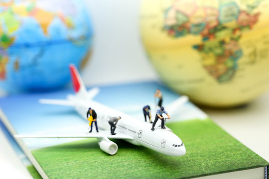 Miniature people : worker clean air plane using for business trip concept.