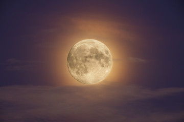 Fototapeta na wymiar Bright full moon against cloudy sky