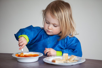 toddler eating tomato soup for lunch