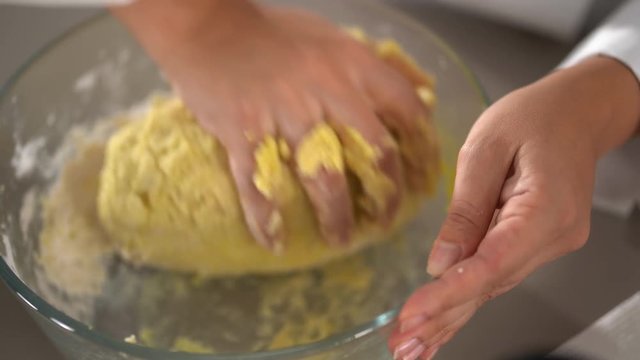 4K cooking footage, close up kneading  dough in glass bowl 
