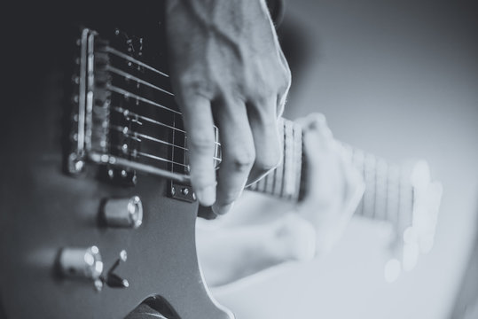 Close up of man playing on electric guitar