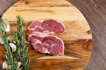 Raw lamb chump slices on chopping board