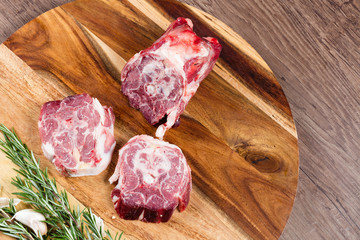 Raw lamb neck slices on chopping board