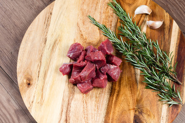 Raw diced lamb on chopping board