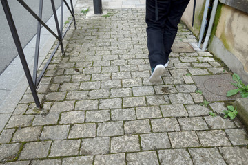 a pedestrian walking on a french street