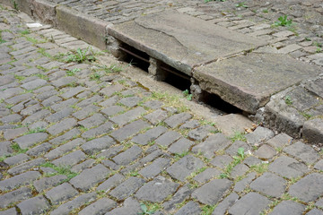 view of a sewer in an old street in France