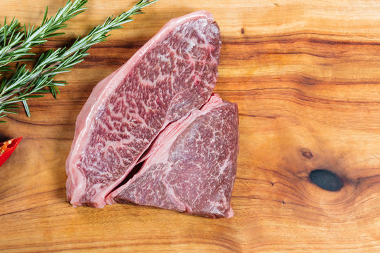 Raw beef wagyu rump steak on chopping board
