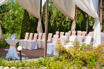 Wedding banquet tables preparing for a wedding outside on a summer day