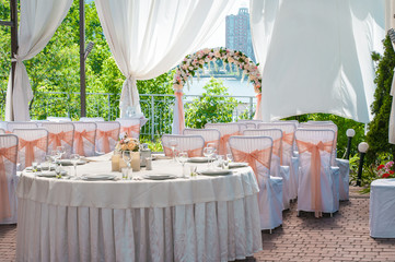 Wedding banquet tables preparing for a wedding outside on a summer day