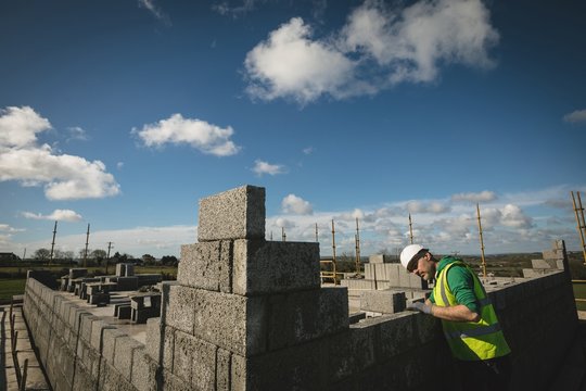 Engineer examining the wall at construction site